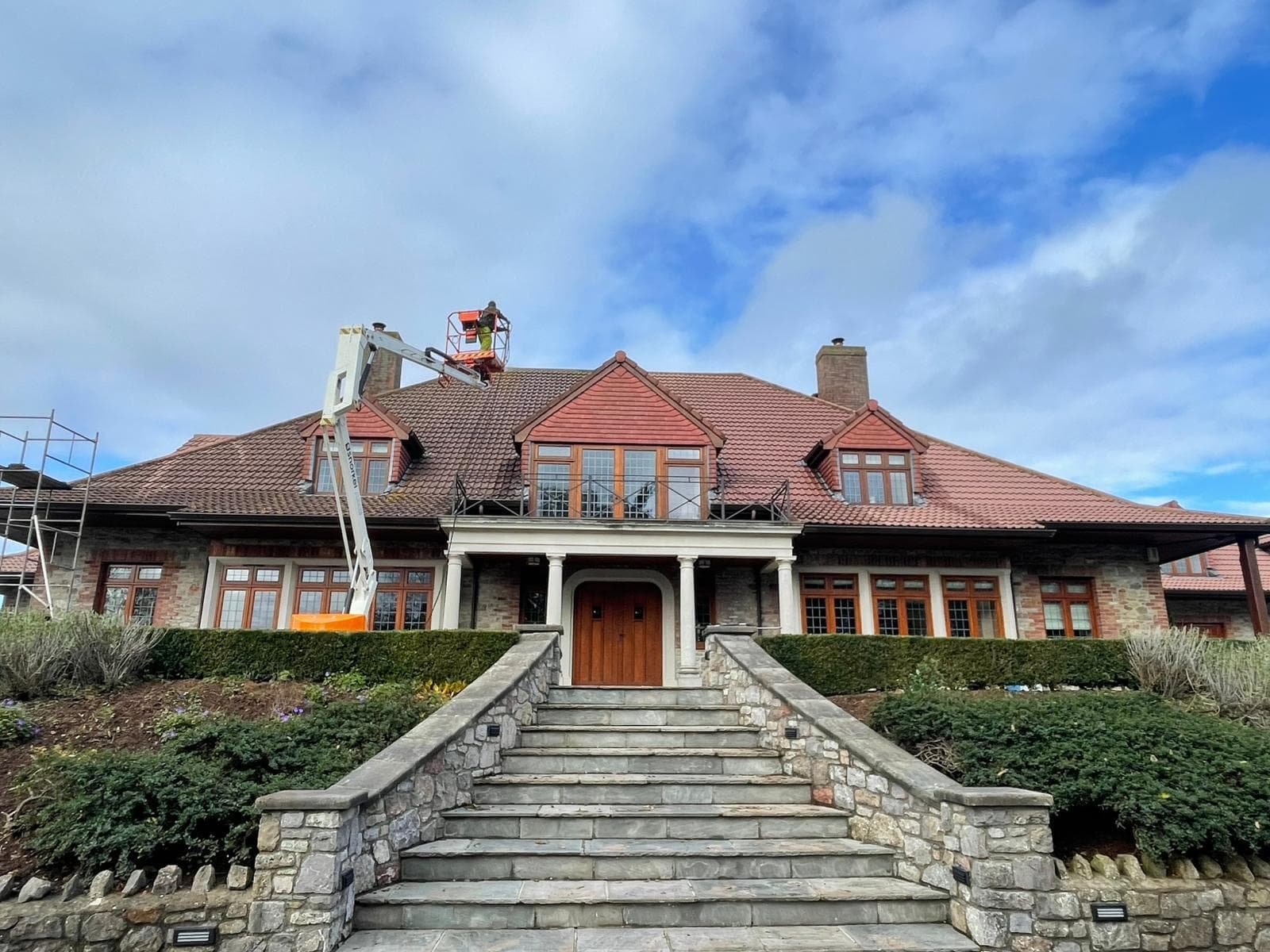 Large house with stone steps during an exterior cleaning job